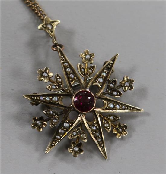 A gem set 9ct gold starburst pendant on fine chain